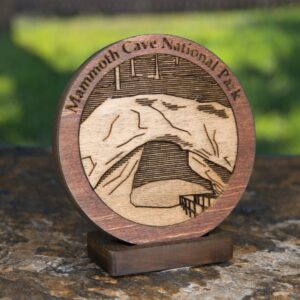 Iconic image of Mammoth Cave National Park engraved on a 2" solid wood medallion with stand