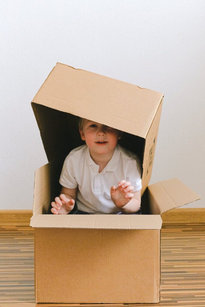 Boy Playing With Boxes used on return policy page